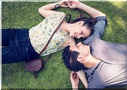 Couple lying in the grass.