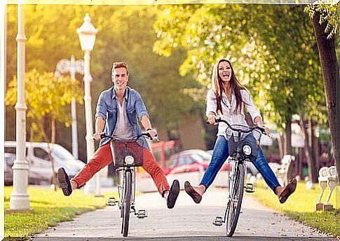 Couples cycling together.