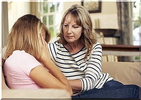 A funer comforts his older daughter