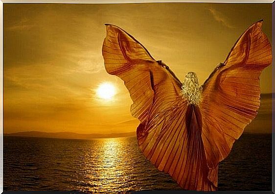 Woman by the sea with wings