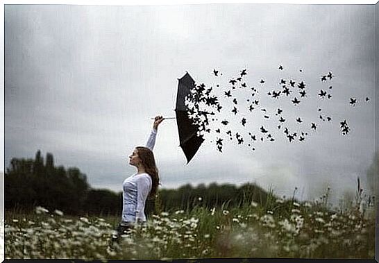 A woman with an umbrella that turns into birds.