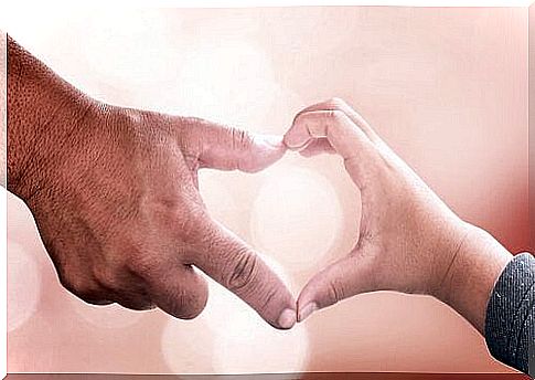 Adult hand and child hand form heart