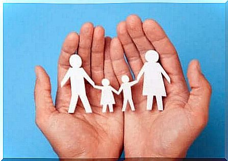 hands holding a paper clip of a family