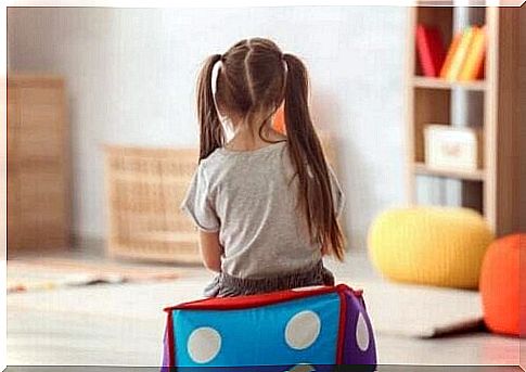 A girl sitting in a room.