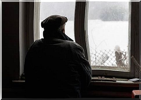 A man looking out of a window.