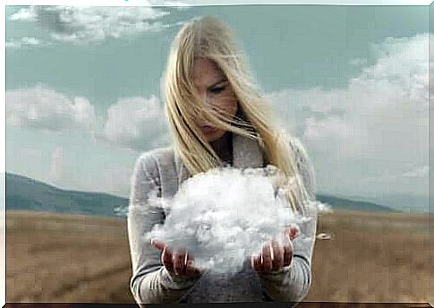 A woman holding a cloud in her hands.