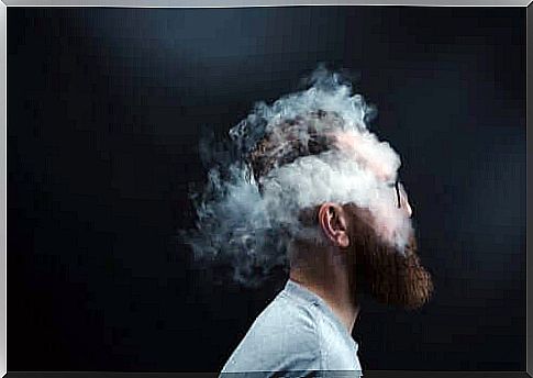 The head of a bearded man is surrounded by clouds of smoke