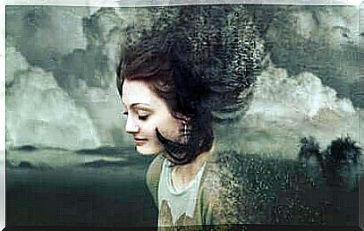 A drawing of a woman who is surrounded and slowly becomes part of a gray sky.