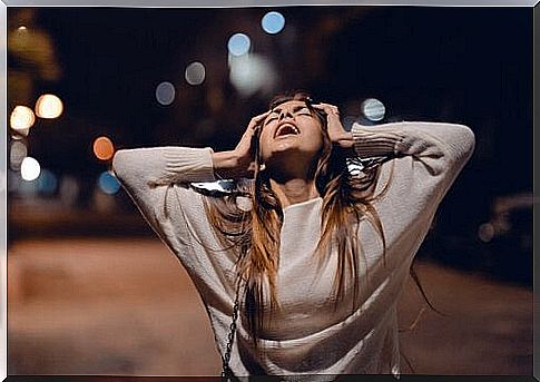 A woman screaming in the street.