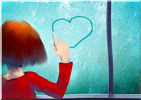 Girl draws heart on window