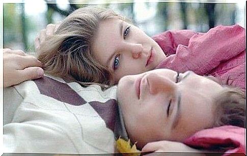 A young couple lying side by side with half-open eyes