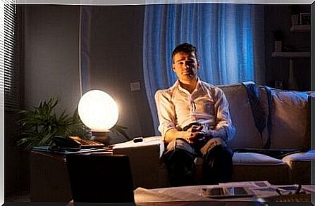 Man with insomnia sitting on the couch