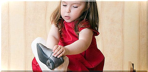 Girl putting on a shoe