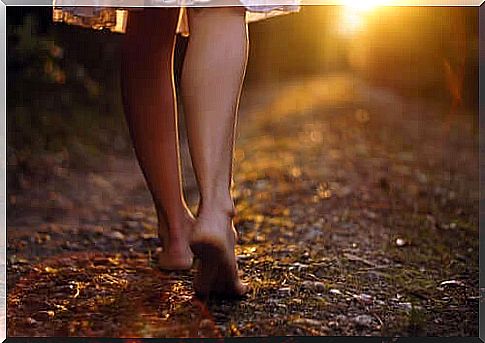 Woman walks barefoot in the woods