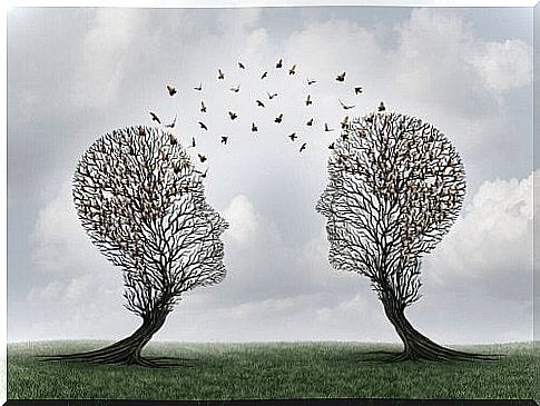 Two trees in the shape of human heads with birds in between.