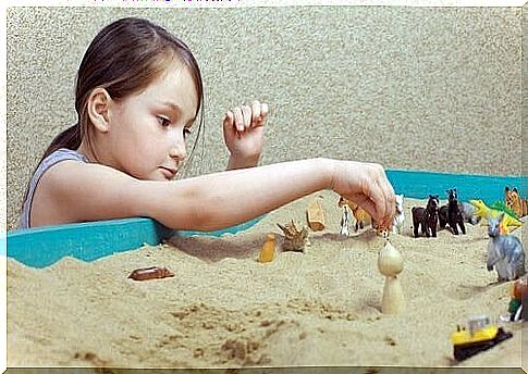 Girl playing with sandbox