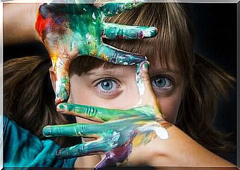 A girl with paint on her hands