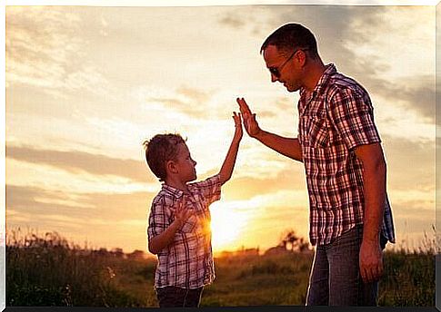 Happy father and son at sunset.