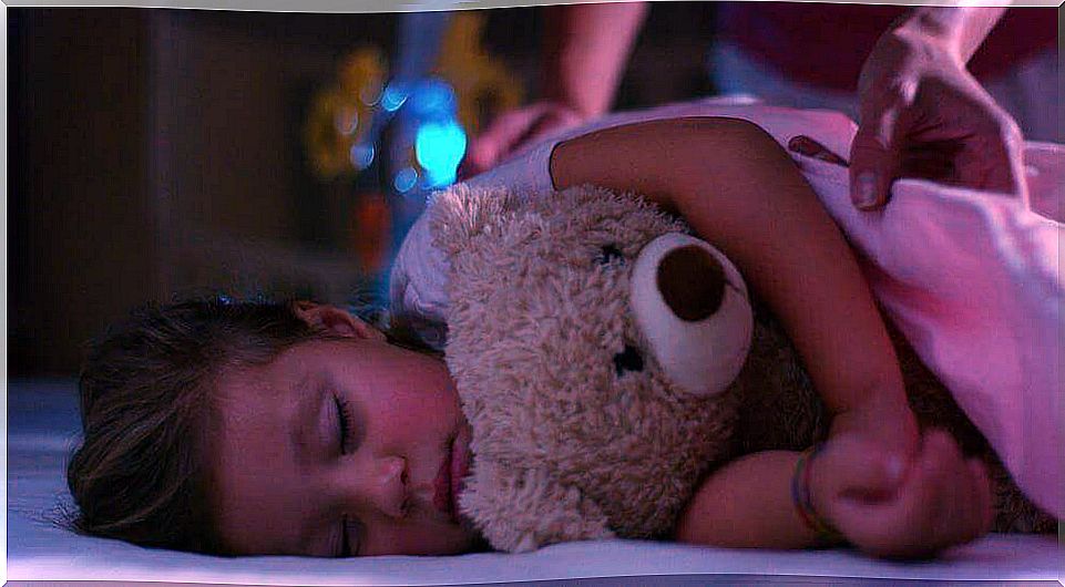 A little girl sleeping with her teddy bear